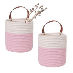 two pink and white baskets sitting next to each other