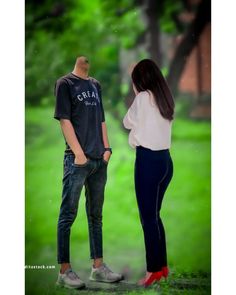 a man and woman standing next to each other in front of a green field with trees