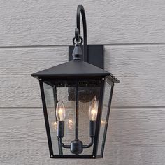 an outdoor wall light with three lights on it