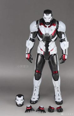 an action figure is posed in front of a gray background with red and white accents