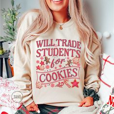 Funny teacher Christmas sweatshirt - a colorful and comfortable gift for teacher lovers. Perfect for the holidays, this cute and cozy sweatshirt makes a thoughtful Christmas gift for your favorite teacher! GILDAN HEAVY BLEND SWEATSHIRT H O W ∙ T O ∙ O R D E R   *  Select a Color *  Select a Size based on the Size Chart *  Add to Cart  *  Please check the Shipping Address to ensure that your order arrives without delay ♡ P R O D U C T∙ D E T A I L S   *  Brand:  Gildan   *  Fabric:  Medium-heavy weight.  50% cotton, 50% polyester.  Ribbed knit collar.   *  Fit:  Runs true to size. Please size up for an oversized look   *  Your shirts are carefully made with attention to small details ♡   C A R E  ∙ I N S T R U C T I O N S   *  Turn inside out.  Cold water wash with like colors only *  Mild Cute Graphic Print Sweatshirt For Gift, Cozy Crew Neck Sweatshirt As Gift, Casual Letter Print Sweater As Gift, Casual Letter Print Sweater As A Gift, Cotton Sweater With Graphic Print As Gift, Graphic Print Cotton Sweater As Gift, Christmas Sweatshirt Gift, Casual Cotton Sweatshirt Gift, Casual Cotton Sweatshirt Perfect As A Gift