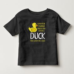 a black t - shirt with a yellow rubber duck on it's chest and the words, always be yourself unless you are in a duck