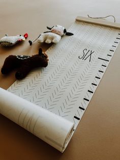 several stuffed animals are laying on top of a paper with the word six in it