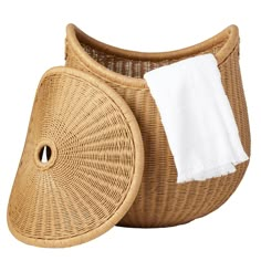 a wicker basket with a white towel on it and another item next to it