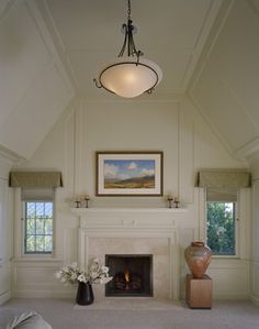 a living room with a fire place and two vases on the floor next to it