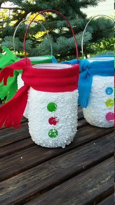 two christmas baskets sitting on top of a wooden table next to each other, decorated with red, white and blue decorations