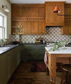 a kitchen with green cabinets and white counter tops