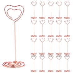 a set of 12 heart shaped metal picks on top of each other with different sizes and shapes