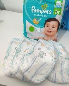 three diapers are sitting next to each other on a table with a bag of wipes