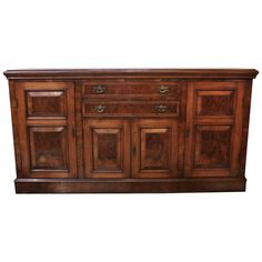 an old wooden sideboard with many drawers