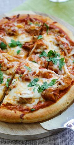 a pizza sitting on top of a wooden cutting board