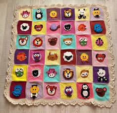 a crocheted blanket with many different animal faces on it, all in various colors