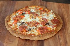 a pizza sitting on top of a wooden cutting board