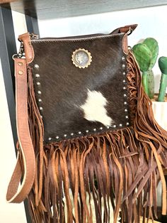 cowhide, coin concho and studded accents, leather fringe and a leather adjustable crossbody strap. 10 x 10” zips closed at top zipper and 2 open pockets inside Zipper pocket on distressed leather box made by American Darling - not Customizable *Hide patterns will vary - select from drop down menu* Tack Sets, Leather Box, Saddle Pads, Purse Strap, Leather Fringe, Distressed Leather, Crossbody Strap, Leather Purses, Cross Body Handbags