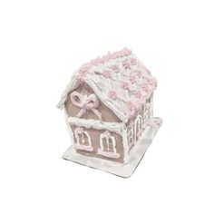 a cake shaped like a house with pink flowers on the roof and bow at the top