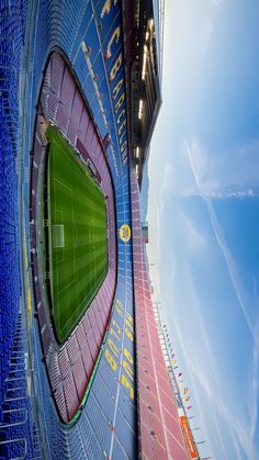 an empty soccer stadium with the sky in the background