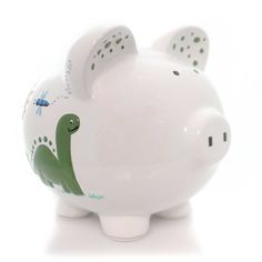 a white ceramic pig with green and blue designs on it's face, sitting in front of a white background