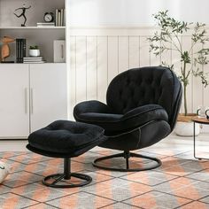 a black chair and ottoman in a living room with an orange rug on the floor