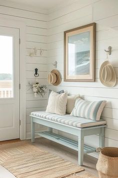 a bench sitting in front of a door with hats hanging on the wall above it