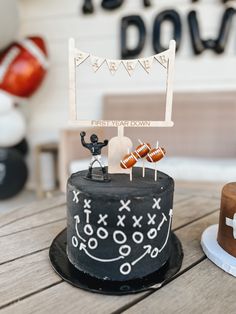 two cakes with decorations on them sitting on a table