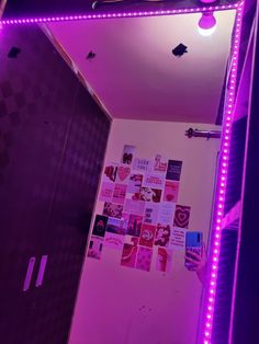 a bathroom with purple lights and pictures on the wall