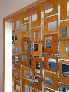 a room divider made out of wood and mirrors