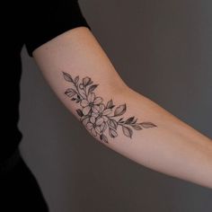 a woman's arm with flowers on it