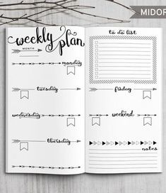 the printable weekly planner is open on top of a wooden table with branches in the background