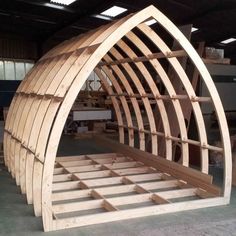 a large wooden boat sitting inside of a building