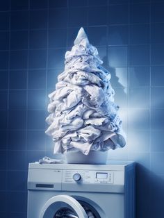 a stack of towels sitting on top of a washing machine