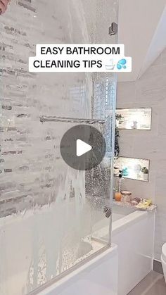 a bathroom with a glass shower door next to a toilet