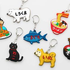 six different key chains with various designs on them, all featuring cats and other animals