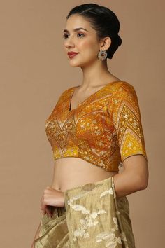 Product Features: Blouse Color: Mustard and Multi Blouse Fabric: Brocade Work: Woven Design Sleeve Length: Elbow length sleeves In Closer: Back Open Padded / Non Padded : Padded Wash Care : Dry Clean Occasion : Festivewear, Partywear, Wedding Guest Product Type : Blouse Disclaimer: There will be slight difference in digital to actual image Formal Long Sleeve Tops For Festivals, Elegant Yellow Tops For Festivals, Fitted Yellow Silk Blouse, Festive Formal Short Sleeve Blouse, Fitted Tops For Festivals, Festive Yellow V-neck Top, Unstitched Yellow Long Sleeve Blouse, V-neck Blouse For Festivals, Fitted Yellow Silk Top