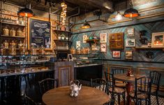 the interior of a restaurant with wooden tables and chairs