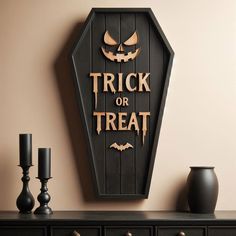 there is a trick or treat sign on the wall next to candles and vases