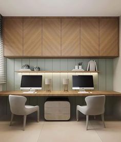 two computer monitors sitting on top of a wooden desk in front of a white chair