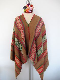 This Poncho is absolutely beautiful and warm, perfect  for the winter and autumn seasons because its fiber is highly warm. This  poncho is brought from Pisac Cusco Peru. It is handwoven by Peruvian artisans with 100% Alpaca in the traditional Andean Method and is a naturally dyed blend of Alpaca, llama and sheep wool. It is a unique garment.  Material: Alpaca blend Measurements: 46x46 inches Will fit people sizes ranging from medium to large.  Color: Brown, beige, red and green. Weight: 2.15 pounds Made in Peru Artisan Poncho For Fall, Artisan Poncho For Fall One Size, Artisan Winter Poncho For Festival, Artisan Alpaca Poncho For Fall, Handwoven Shawl Poncho For Winter, Bohemian Handwoven Poncho For Winter, Handwoven Brown Poncho For Fall, Traditional Alpaca Cape For Winter, Traditional Brown Winter Cape