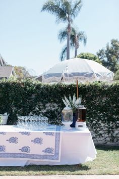 a table with an umbrella and wine glasses on it