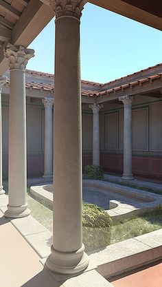 an empty courtyard with columns and benches