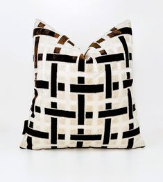 a black and white pillow sitting on top of a table