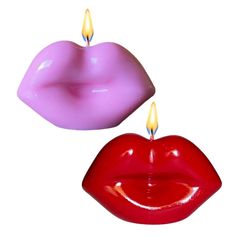 two candles that are shaped like lips and one has a candle in the shape of a heart