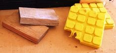 two pieces of wood sitting on top of a table next to a keyboard and mouse pad