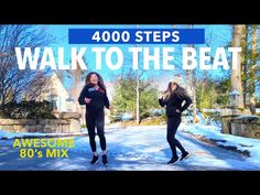 two women in wetsuits are running down the street with snow on the ground