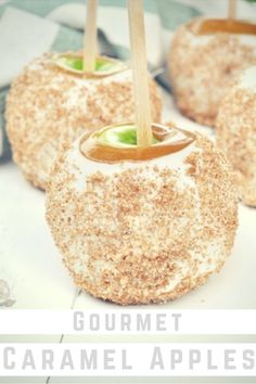 apples with caramel and sugar on them sitting on a white tablecloth covered surface