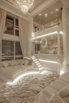 a large white bed sitting under a chandelier in a bedroom next to a window