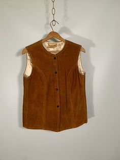 "Such a gorgeous nostalgic suede vest. Vintage 1960s. Lovely brown. Blacks snap closure. Tag reads 'The Leather Loft Vancouver BC'.  Pit to pit - 19\" across, 38 around. Length - 24\" inches Made in Vancouver Canada *there is a scuff mark on the back, check photos, it's not as and take no beauty away from this piece that's like 60 years old. Thank you for looking, please FAVORITE my shop to see new things added often and also follow along on Instagram @blackgardenvintage to peek at new things in Stay Groovy, Suede Vest, Shop Owner, Vancouver Canada, Vest Outfits, Vancouver Bc, New Things, Vintage 1960s, Snap Closure