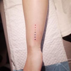 a woman's arm with four dots on the left side of her body and one dot in the middle