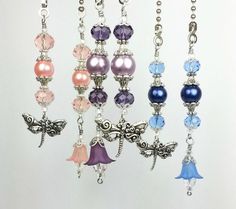 several necklaces with different colored beads hanging from them