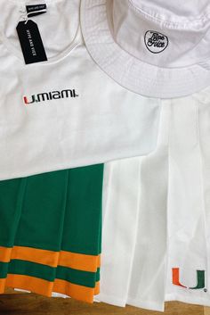 several different colors and sizes of clothing on a wooden surface with the name umma written on it