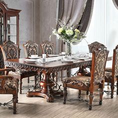 an ornate dining room set with fancy chairs